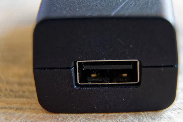 Usb charger plug on wooden background — Stock Photo, Image