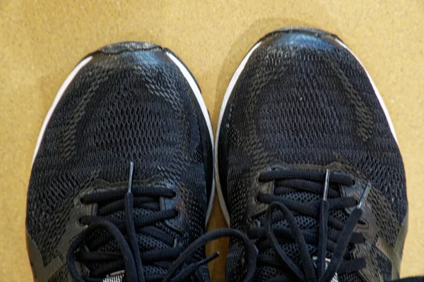 Black sneakers running shoes. Close up of men sport shoes.