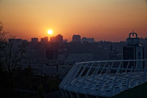 Stadium construction. Aerial view of the stadium roof on the city's background. Sunset behind stadium for soccer.