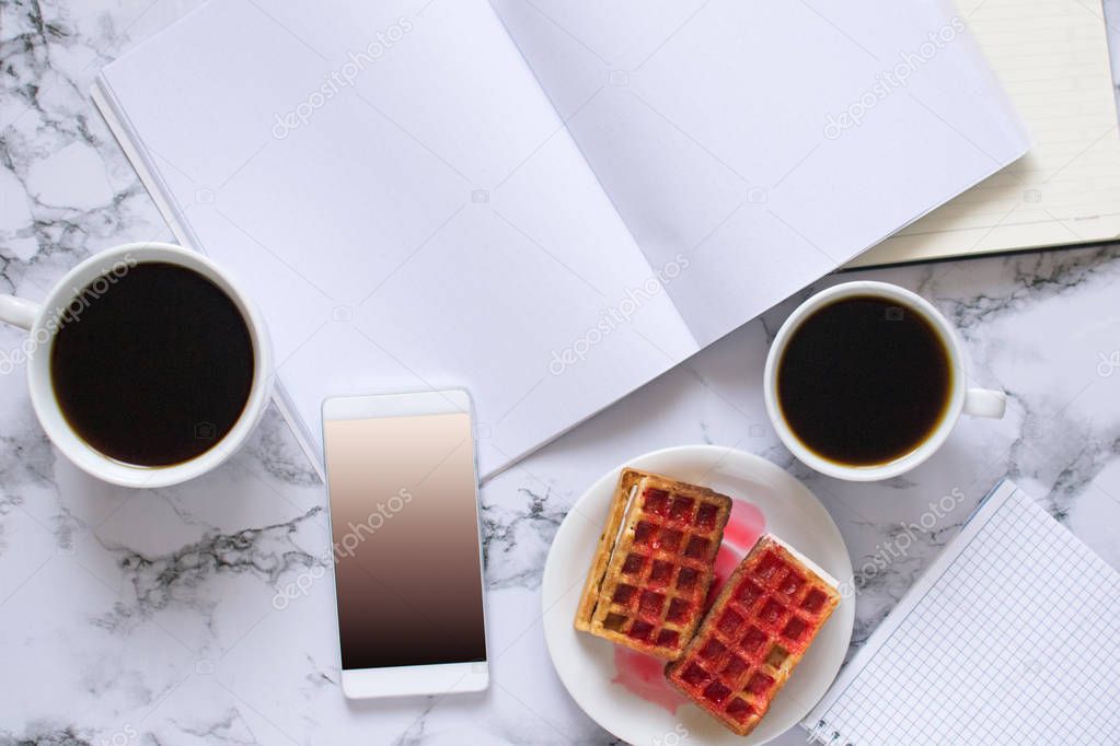 buisness lunch with two coffe anf waffles and planning the day and smartphone