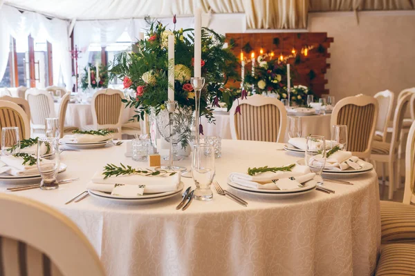 flower composition and candles in the restaurant. Wedding dinner