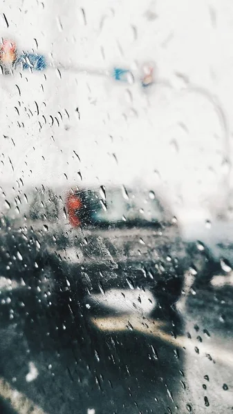 Drops of rain on the window car. View from car on road in the rainy day.