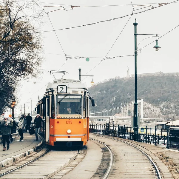 Tram stopped on the tramway station. Orange tram on the railway in Budapest, Hungary