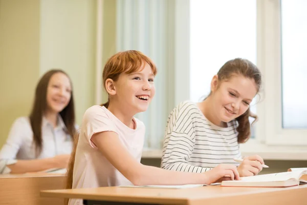 3 student girls are sitting at a Desk — Stock Photo, Image