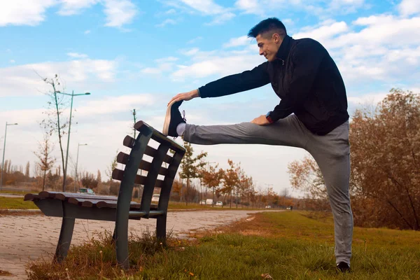 Sporty Man Stretching Bench Jogging Outdoors Park — Stock Photo, Image