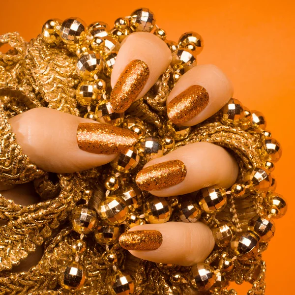 glittered orange nails