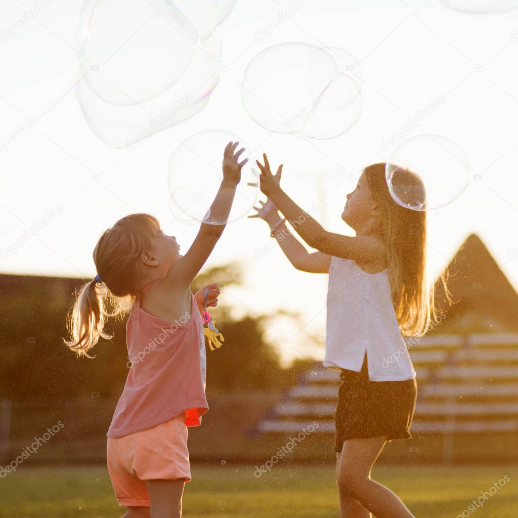 girls playing soap bubbles