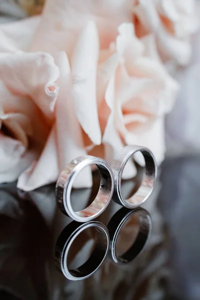 Δαχτυλίδια Γάμου Βρίσκονται Ένα Τραπέζι Δίπλα Ένα Μπουκέτο — Φωτογραφία Αρχείου