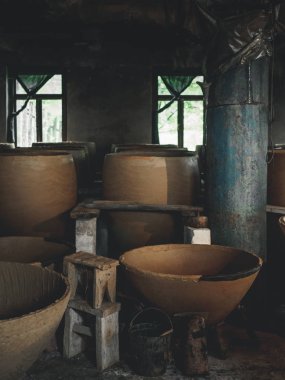 big clay cisterns for producing wine in workshop in georgia clipart