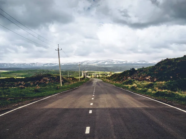 Scenic shot of empty road with mountains on background, Armenia — Stock Photo