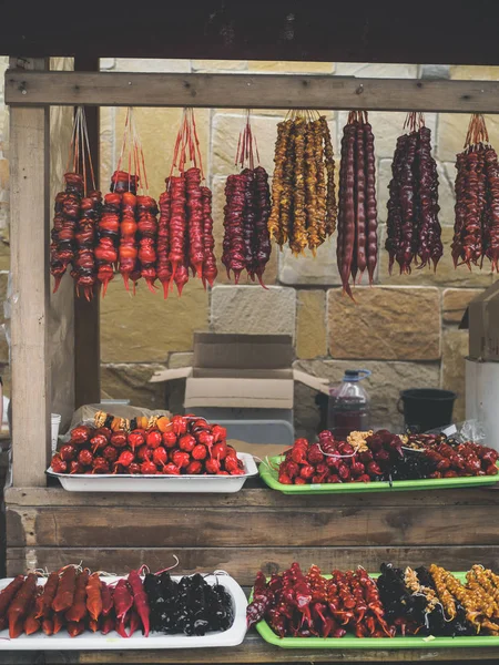 Sweet tasty churchkhela hanging on threads at georgian market — Stock Photo