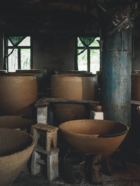 Big clay cisterns for producing wine in workshop in georgia — Stock Photo