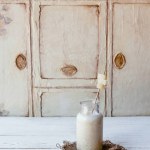 Fresh healthy smoothie in bottle on white table