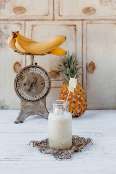 Fresh healthy tropical smoothie on white table