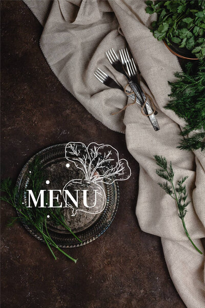 top view of vintage plate with fennel and forks with tablecloth on dark surface, menu lettering