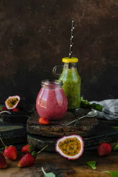 Organic fruit smoothie on wooden background with herbs and berries — Stock Photo