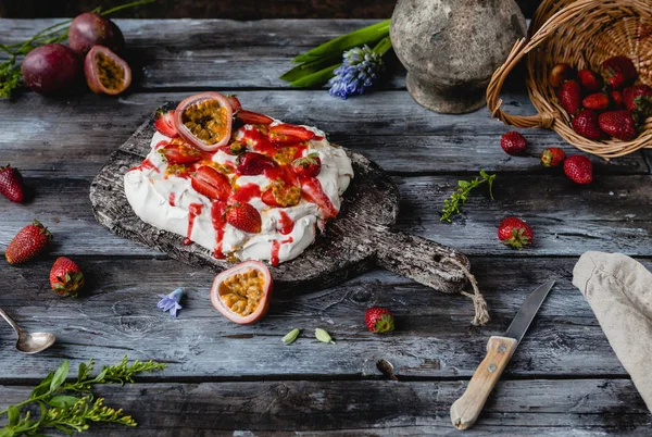 Gustosa torta di meringhe alla fragola e frutto della passione su tavola di legno — Foto stock