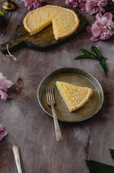 Stück leckerer Zitronenkuchen auf Teller auf Holztisch — Stockfoto