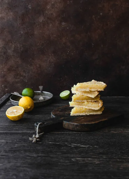 Pieces of delicious lemon pie on cutting board — Stock Photo