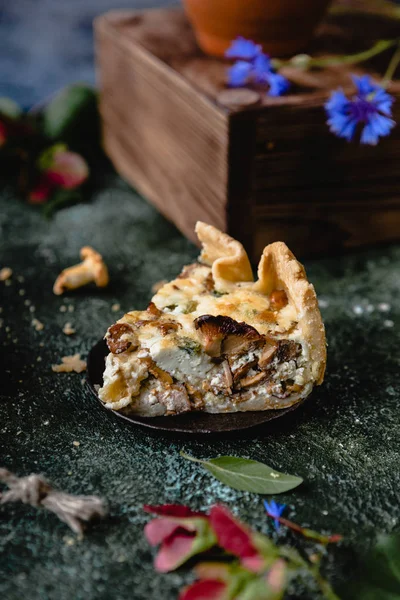 Piece of appetizing pie with mushrooms on wooden table — Stock Photo