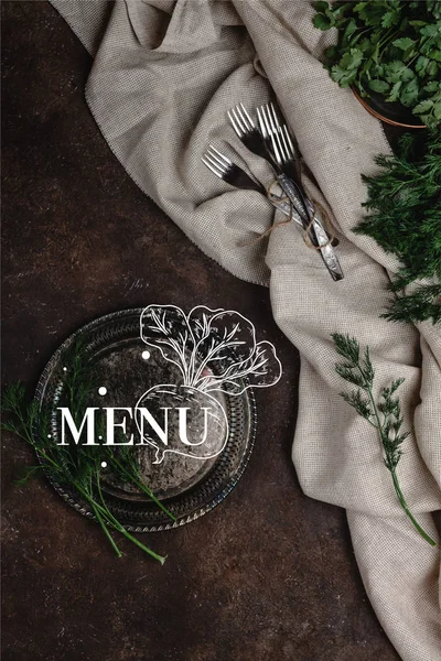 Top view of vintage plate with fennel and forks with tablecloth on dark surface, menu lettering — Stock Photo