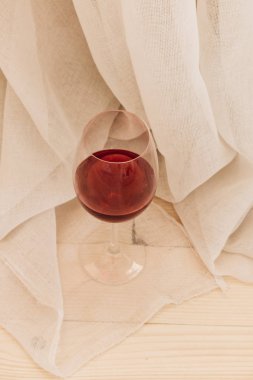 kadehinin ahşap masa ve beyaz Tekstil kırmızı şarap ile 