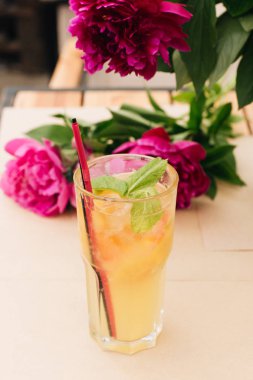 lezzetli tropikal kokteyl ile nane yaprakları, masaya pembe peony çiçek 