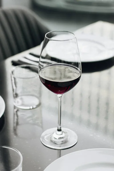 wineglass with red wine on table in restaurant