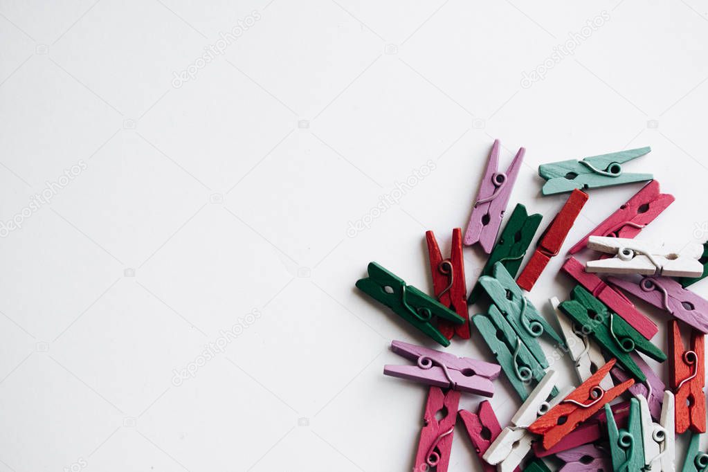 pile of scattered clothes pegs isolated on white background