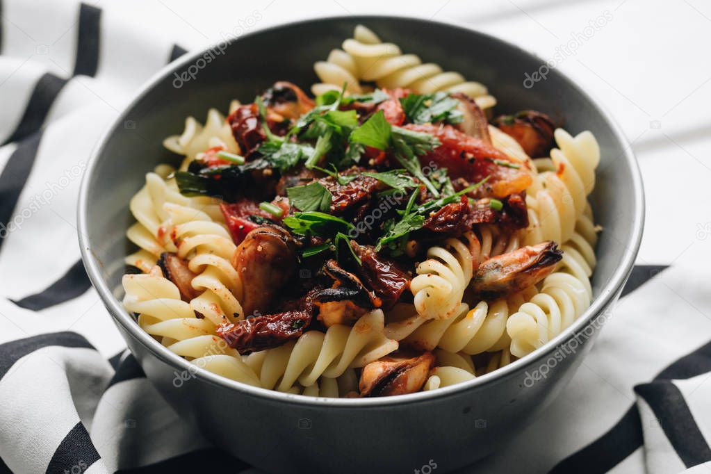 delicious pasta with tomatoes, mussels and herbs 