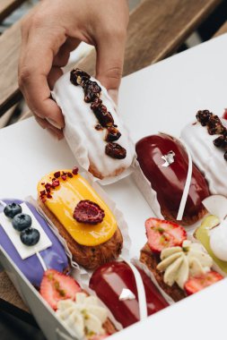 Erkek el ile sır, lezzetli pasta alarak renkli tatlı