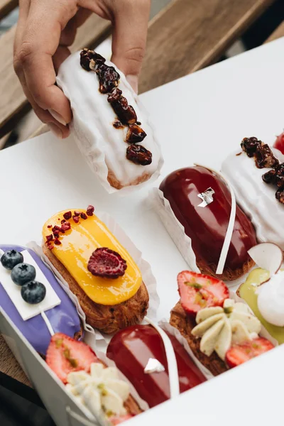 Male Hand Taking Delicious Eclair Glaze Colorful Dessert — Stock Photo, Image