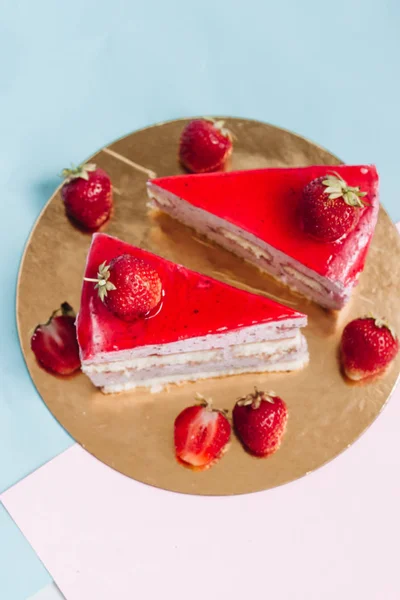 stock image two pieces of delicious cake with strawberries, sweet dessert 