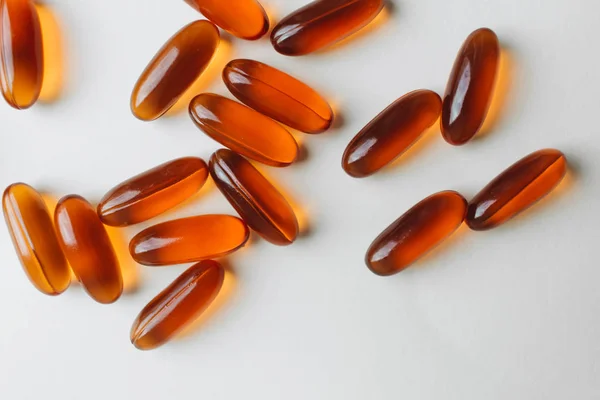 pile of scattered capsules with medication on white background