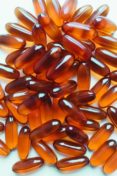 pile of scattered capsules with medication on white background