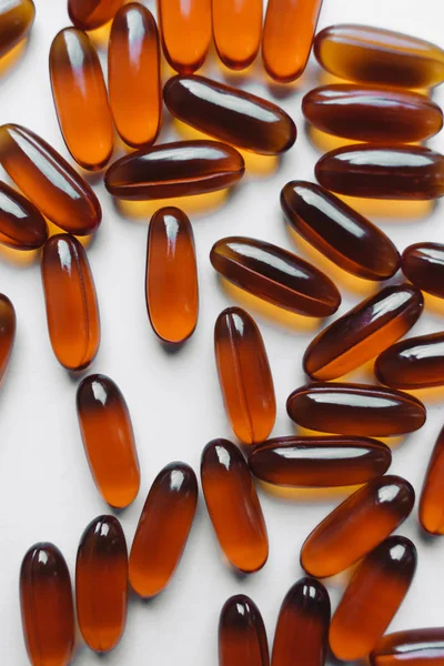 pile of scattered capsules with medication on white background