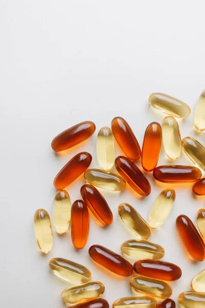 pile of scattered capsules with medication on white background