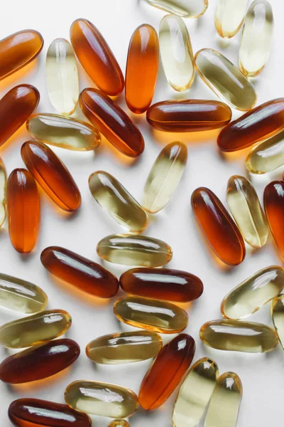 pile of scattered capsules with medication on white background