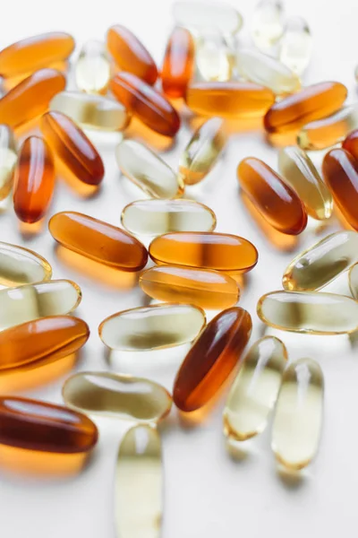 pile of scattered capsules with medication on white background