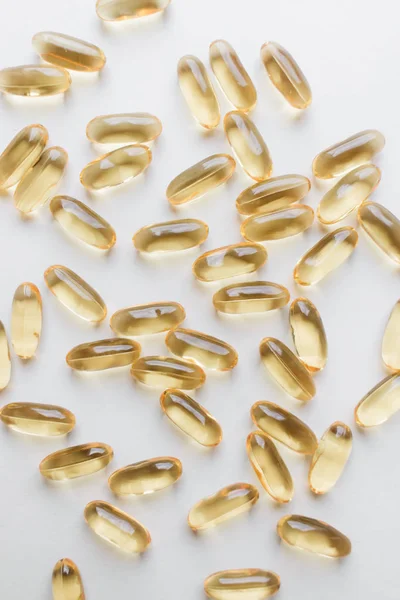 pile of scattered capsules with medication on white background