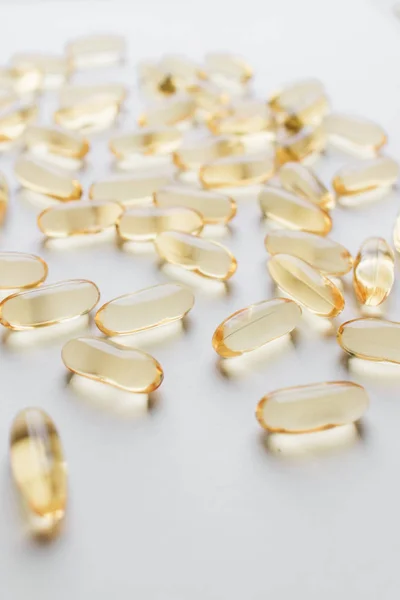 pile of scattered capsules with medication on white background