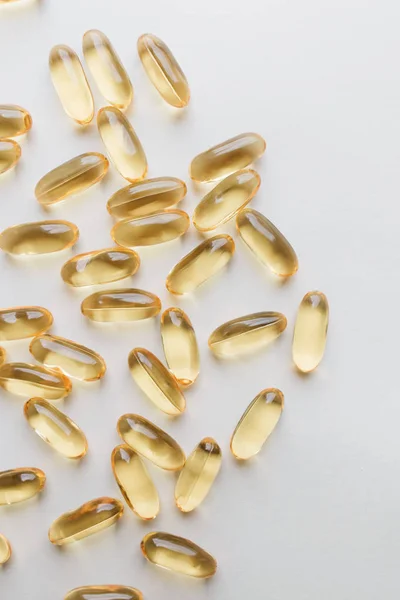 pile of scattered capsules with medication on white background