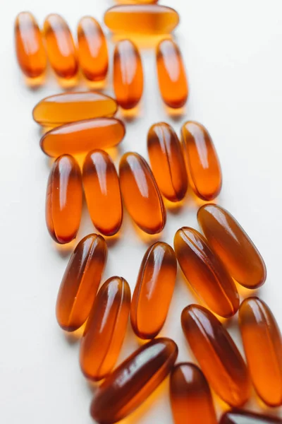 pile of scattered capsules with medication on white background