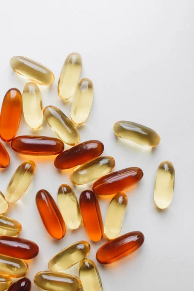 pile of scattered capsules with medication on white background