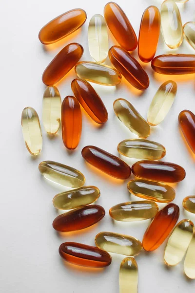 pile of scattered capsules with medication on white background