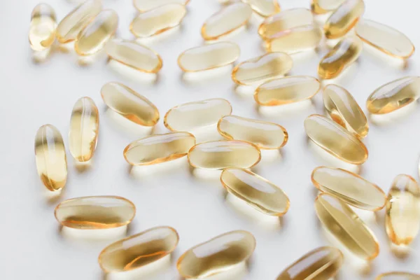 pile of scattered capsules with medication on white background