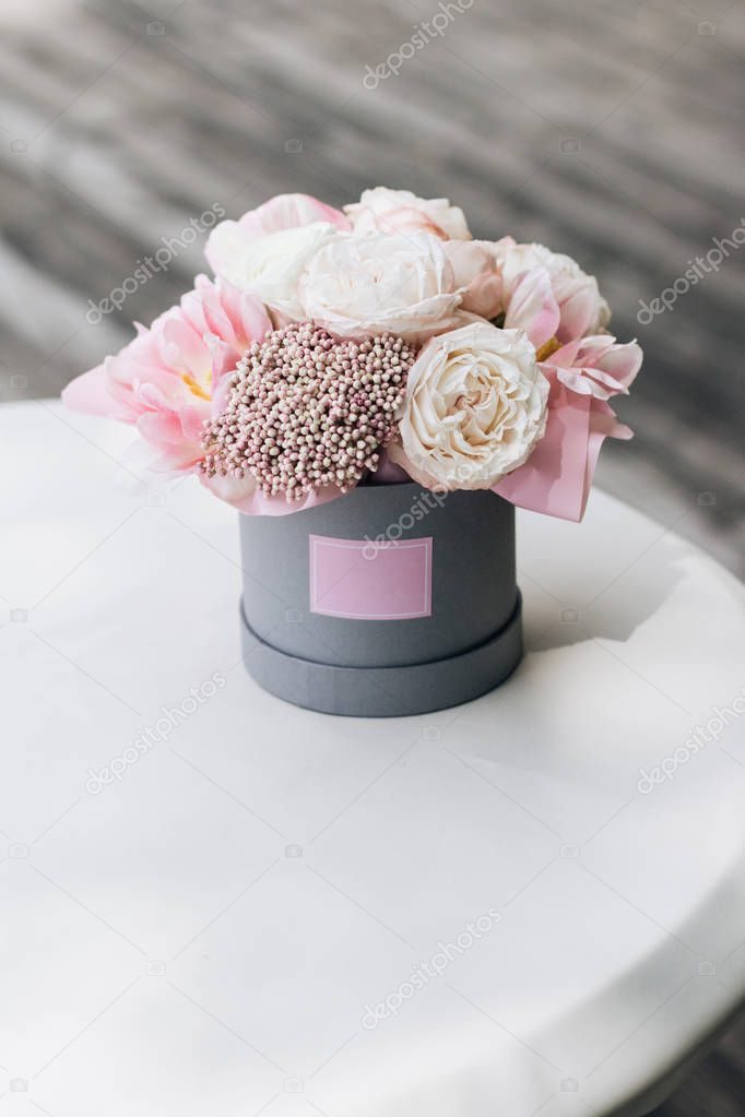 beautiful spring bouquet with tender pink flowers on white table