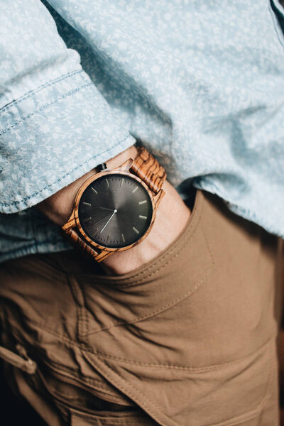 male hand wearing stylish wristwatch