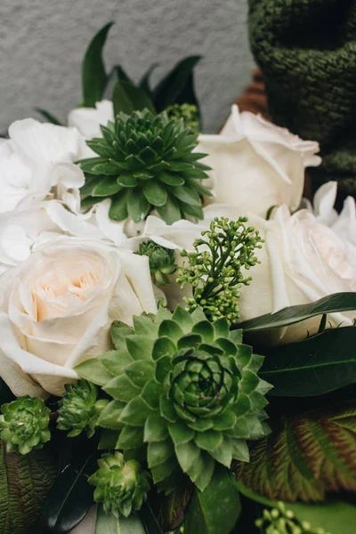 beautiful bouquet with white flowers and exotic green plants