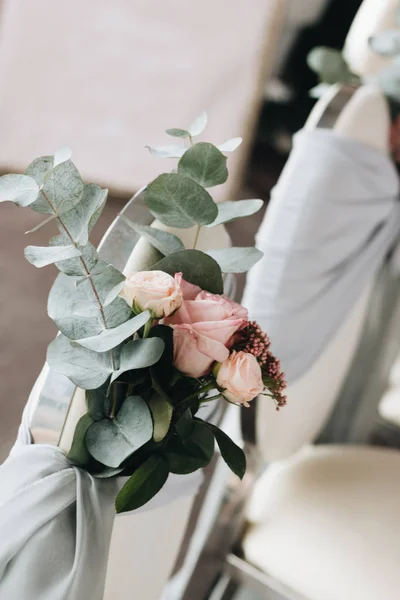 chairs decorated with flowers, wedding style